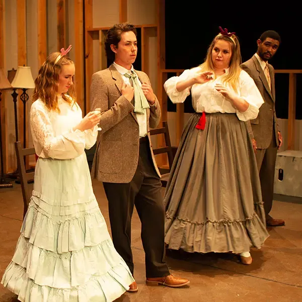 Group of four students performing in a play